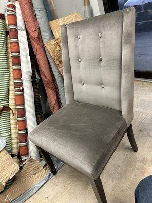 Dining chairs reupholstered in gray velvet with tufted