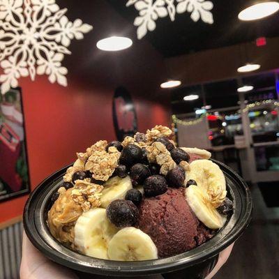 Açaí bowl with blueberries, granola, bananas, and peanut butter