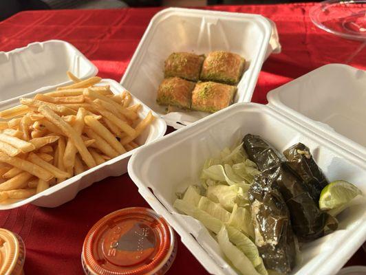 Stuffed grape leaves, fries, pistachio baklava, chicken gyro platter, beef and gyro platter and hummus.