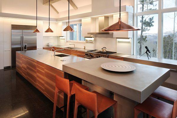 Cabinets in Apple Veneer with Stainless Steel countertop and Concrete Bar top