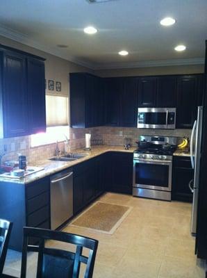 Kitchen remodel--After. We re-stained the cabinets, installed new granite countertops, travertine backsplash, and new applian...