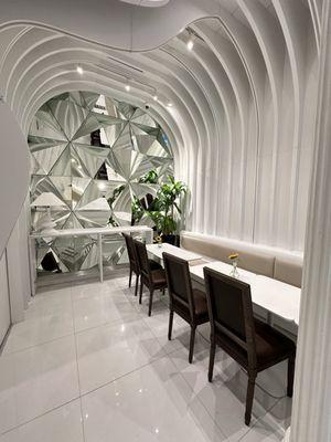 Artistic white waves and mirrored glass seating area. Stunning!