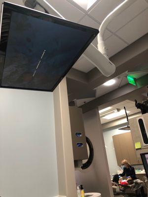 TV coming down from the ceiling as entertainment to watch while you're getting your teeth taken care of