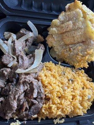 Bistec (steak) Dinner with yellow rice, and tostones.