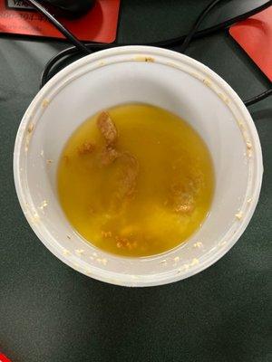 The bucket of chicken in oil.