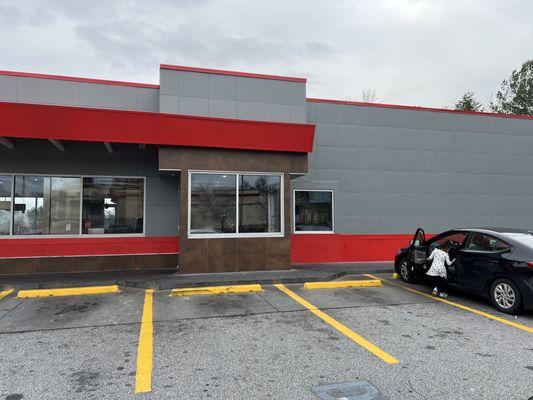 Her child unattended playing in the parking lot.