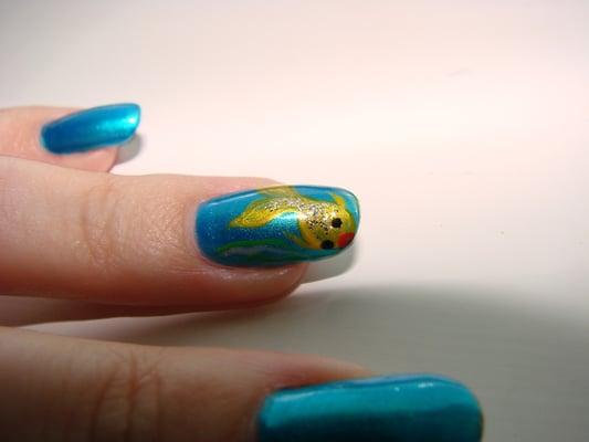 A fish drawn by hand by an Envision Nails technician.