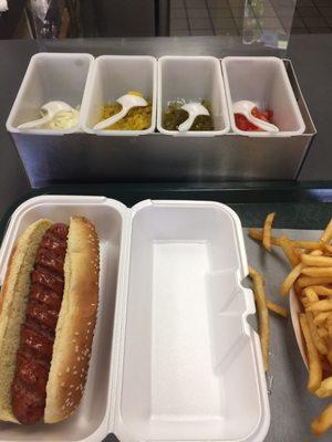 Spicy polish sausage dog with fries and condiments to serve your self