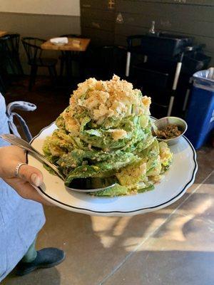 Homemade Caesar salad stacked to the heavens