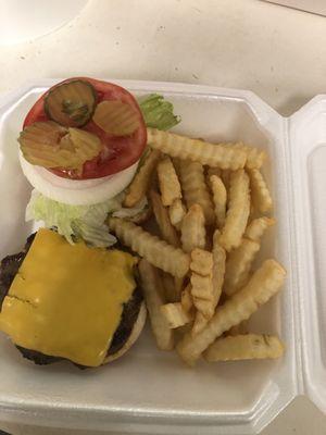 Cheese burger all the way on a toasted bun with French fries.