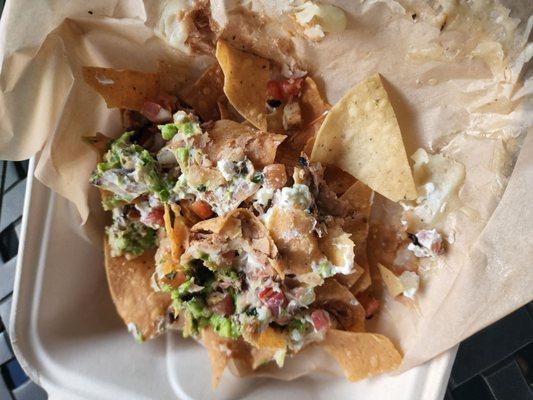 Chicken nachos with almost burnt chips.