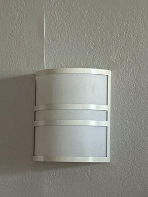 Light fixture barely holding on due to wall seam cracks. Room smelled like mold.