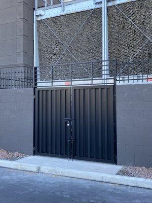 New Double gate with top fixed panel to extend the height to match height of new CMU wall extension fencing