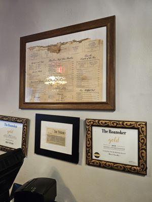 Some of the restaurant's awards framed and hanged from the wall together with a copy of the first menu.