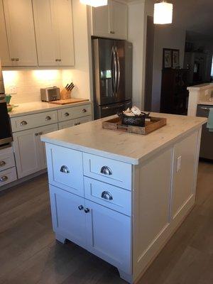 Designers Choice cabinetry in Shaker style.  Corian countertop in Clamshell.