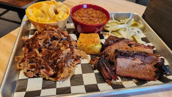 Generous portions of pulled pork, brisket, bbq beans and mac. Cornbread and pickles to top it off.