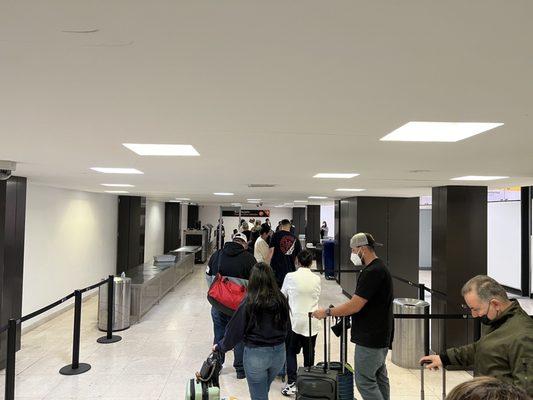 Long line to cross and enter the airport. Only one lane open.