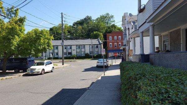 At the stop sign on Liberty Street , there is a posted sign saying 'Ele-fant bakery' pointing down the side street.