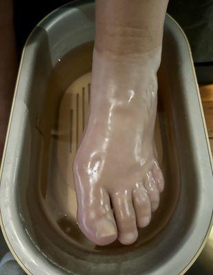 Warm paraffin wax foot dip