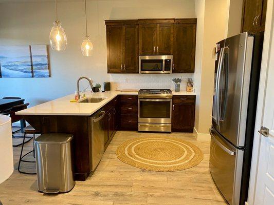 Kitchen area, fully stocked, left side door leads out to patio.