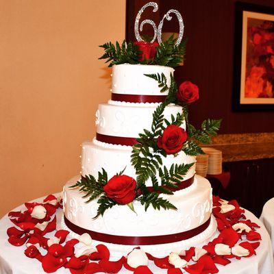 flowers on the cake and around rose petals from Vi's Florist