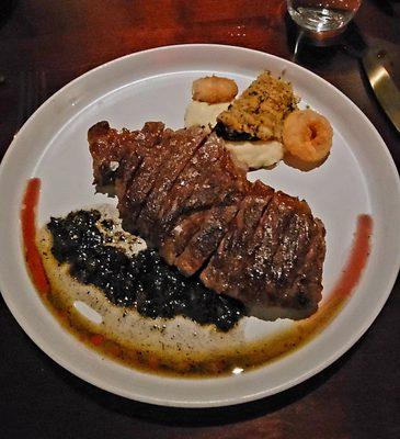 Small Ribeye two tiny Onion rings Tablespoon of Potatoes and piece of Mushroom cap.