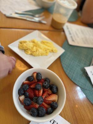 side of scrambled eggs and fruit