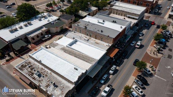 High Solid Silicone Coating to eliminate natural wear and tear on a roof in downtown.