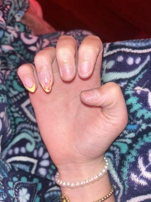 Photo of my daughter's nails that were just done 4 days ago & they are already fallen off.