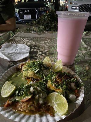 Two Al pastor tacos and a suadero mulita all dressed up and a strawberry horchata