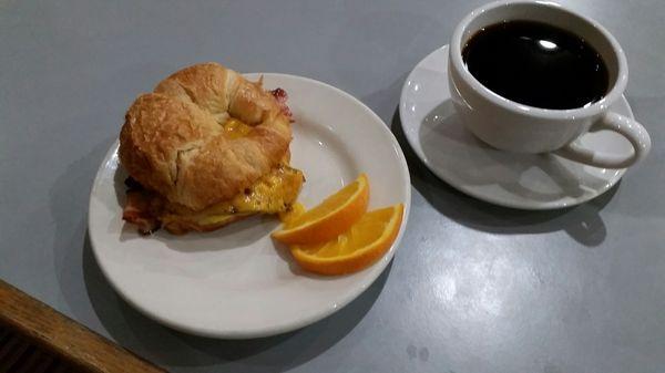 Breakfast sammich, bacon egg and cheese on a croissant, with a cuppa coffee of course.