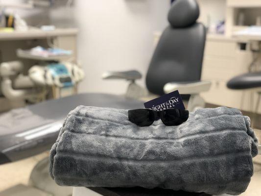 Relax with sunglasses and a blanket during your appointment