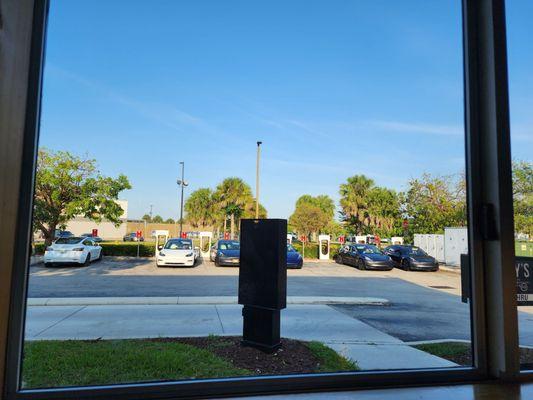 Eat at the restaurant as you charge your tesla .