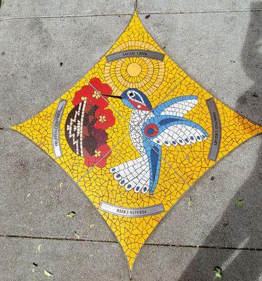 Humming bird tile work in front of their store