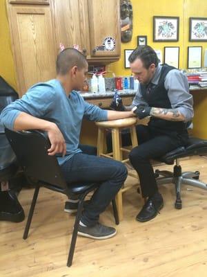 My husband getting his tattoo