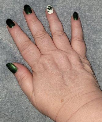 Green nails with white accent nail with 4 leaf clover.