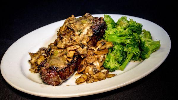 NY strip steak smothered in freshly sautéed mushrooms