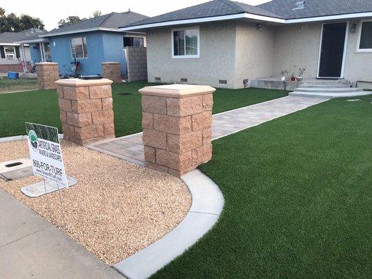 American made Pinehurst turf, Orco pavers, 6' tall cinderblock wall and split face decorative pillars installed in Anaheim.