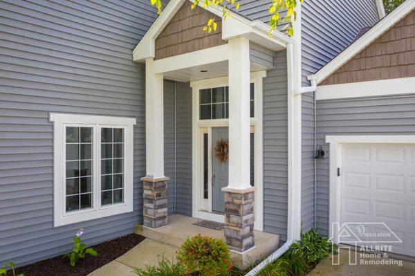 Modern columns with Versetta stone bases, bold trim & accented gables gave this home a contemporary look and great curb appeal.