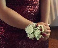 Corsage with ribbon to match dress.