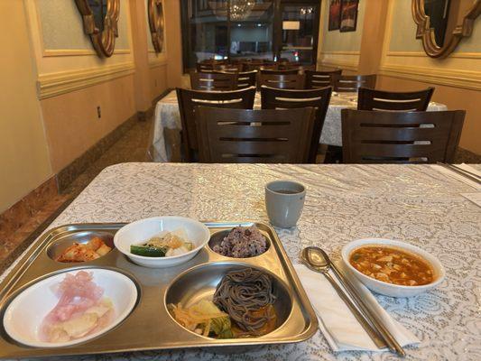 Kimchi sampler - around 9 different types of kimchi with rice, noodles and soup.