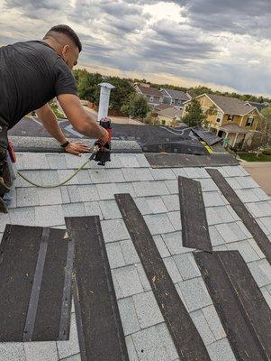 Torn off shingles being reinstalled. Folded and creased shingles being reinstalled.