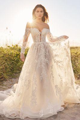 The sheer bishop sleeves and illusion back evoke fairytale vibes.