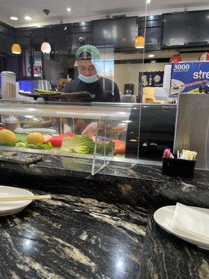 This guy was touching his face and making the sushi at the same time