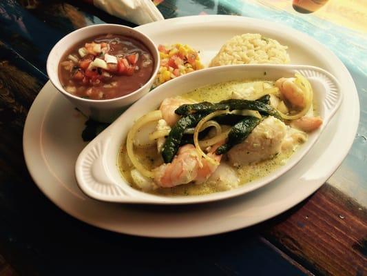 Mariscos Poblanos is a mix of shrimp scallops fish with a white creamy sauce pot beans and with rice.