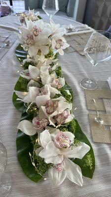 White Orchids with greenery and Thai leaves