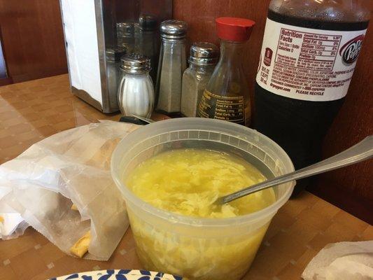 Egg drop soup in plastic container.