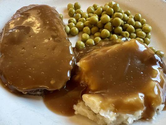 Senior meatloaf dinner with mashed potatoes and peas