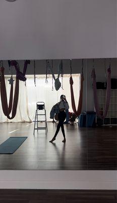 Mirrors featuring the beautiful hammocks used for aerial yoga.