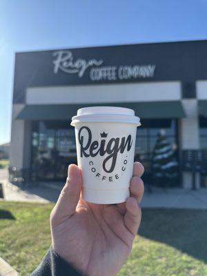 Coffee cup in front of building